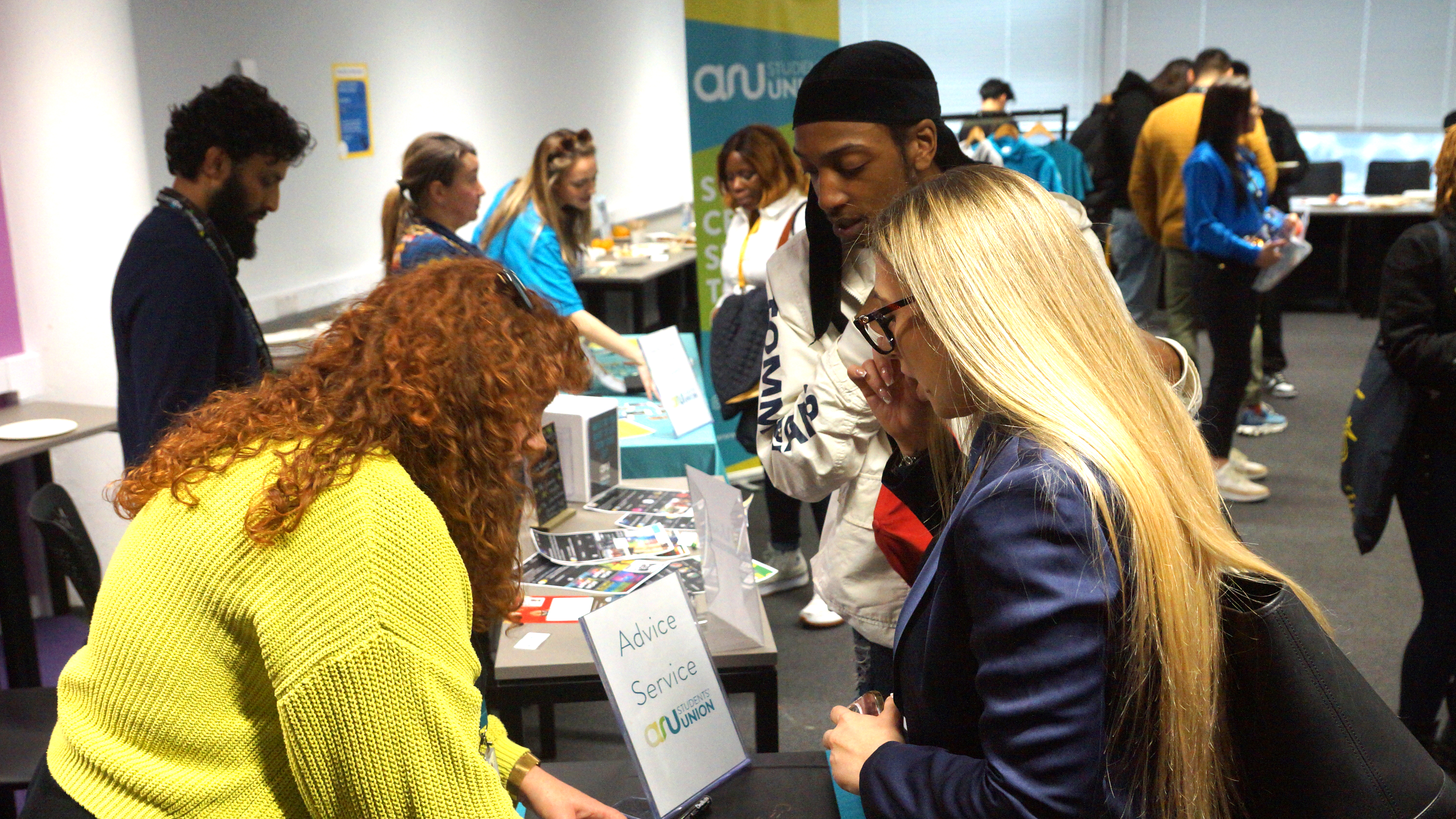 Students chatting at a Welcome Fair stall