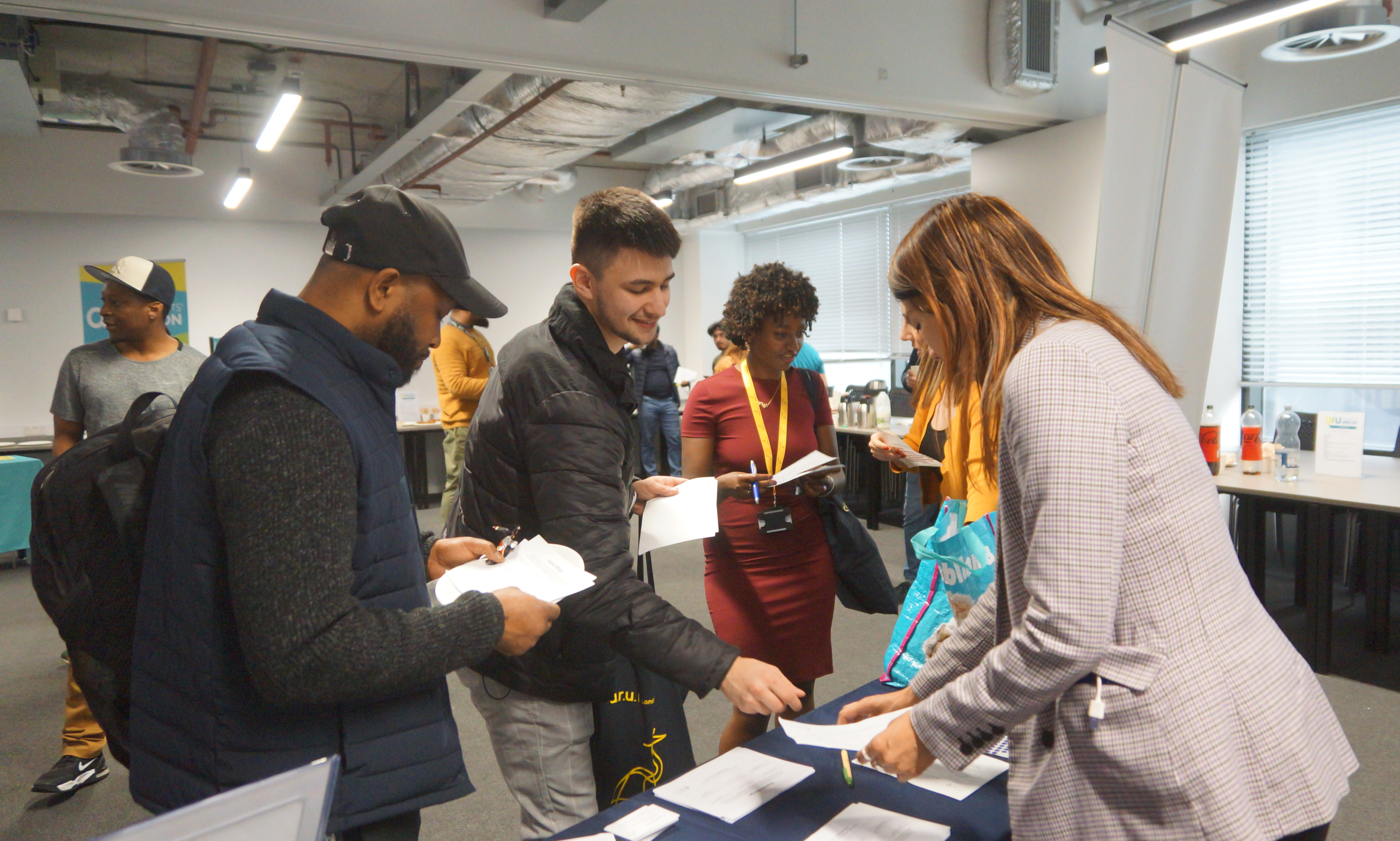 Students chatting at a Welcome Fair stall